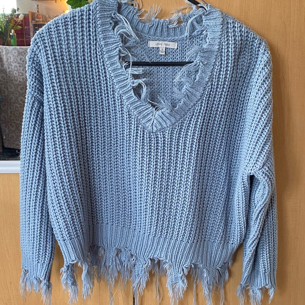 medium cropped blue sweater. distressed